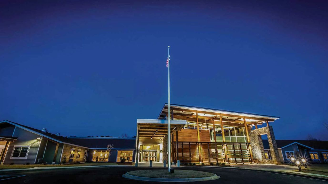Exterior view of Wesley Commons facility at dusk