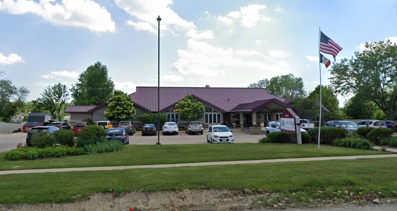 Building exterior with parking and flag