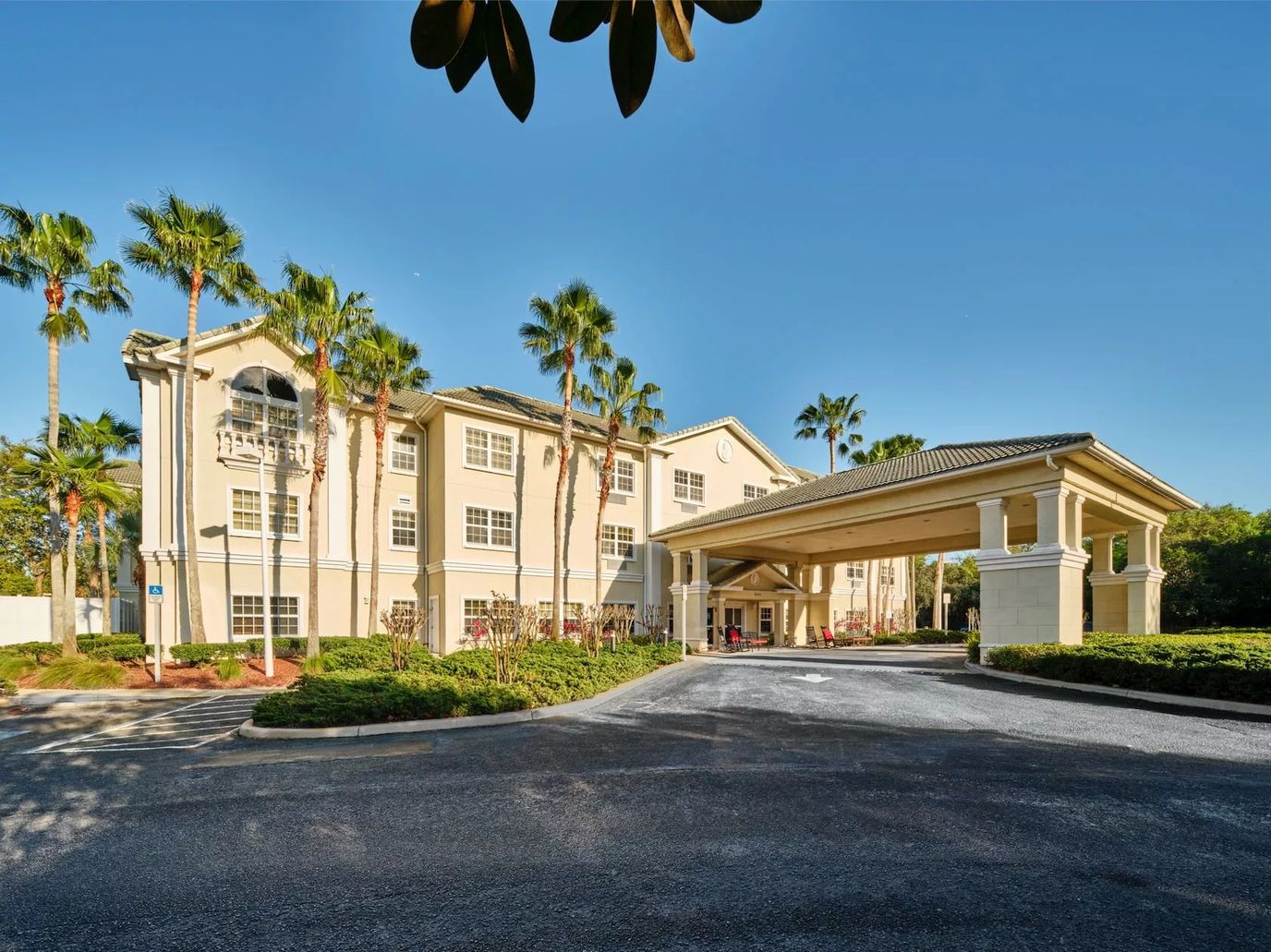 Exterior view of Wickshire Countryside facility with palm trees