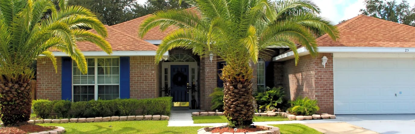 Exterior view of a single-story building with palm trees