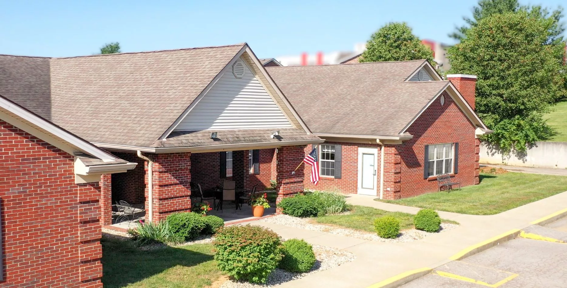 Exterior view of Bluegrass Assisted Living building with landscaping