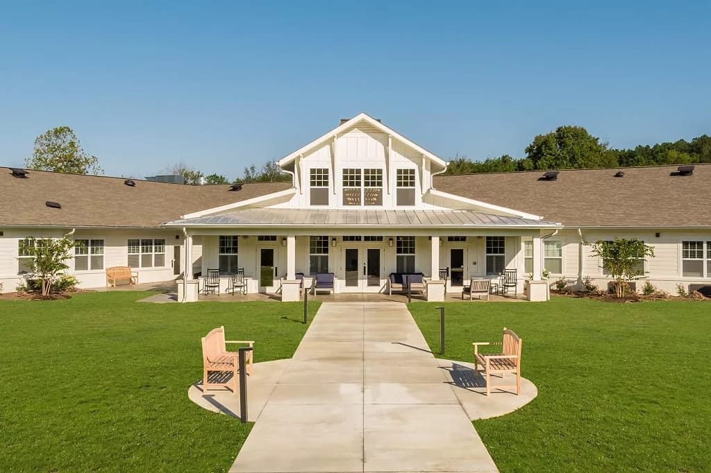 Exterior view of Dominion Senior Living building with lawn