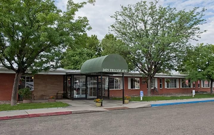 Exterior view of the facility with green awning and trees