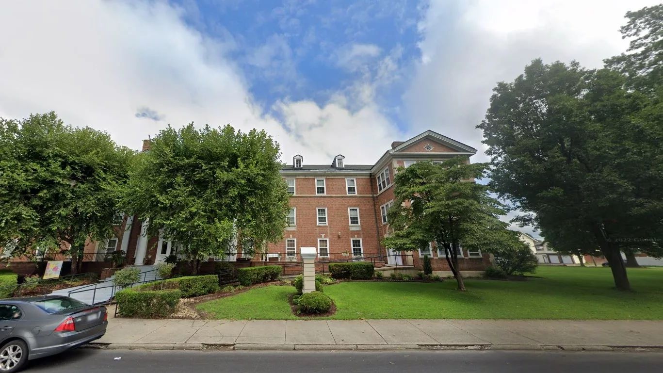Exterior view of the assisted living facility with greenery