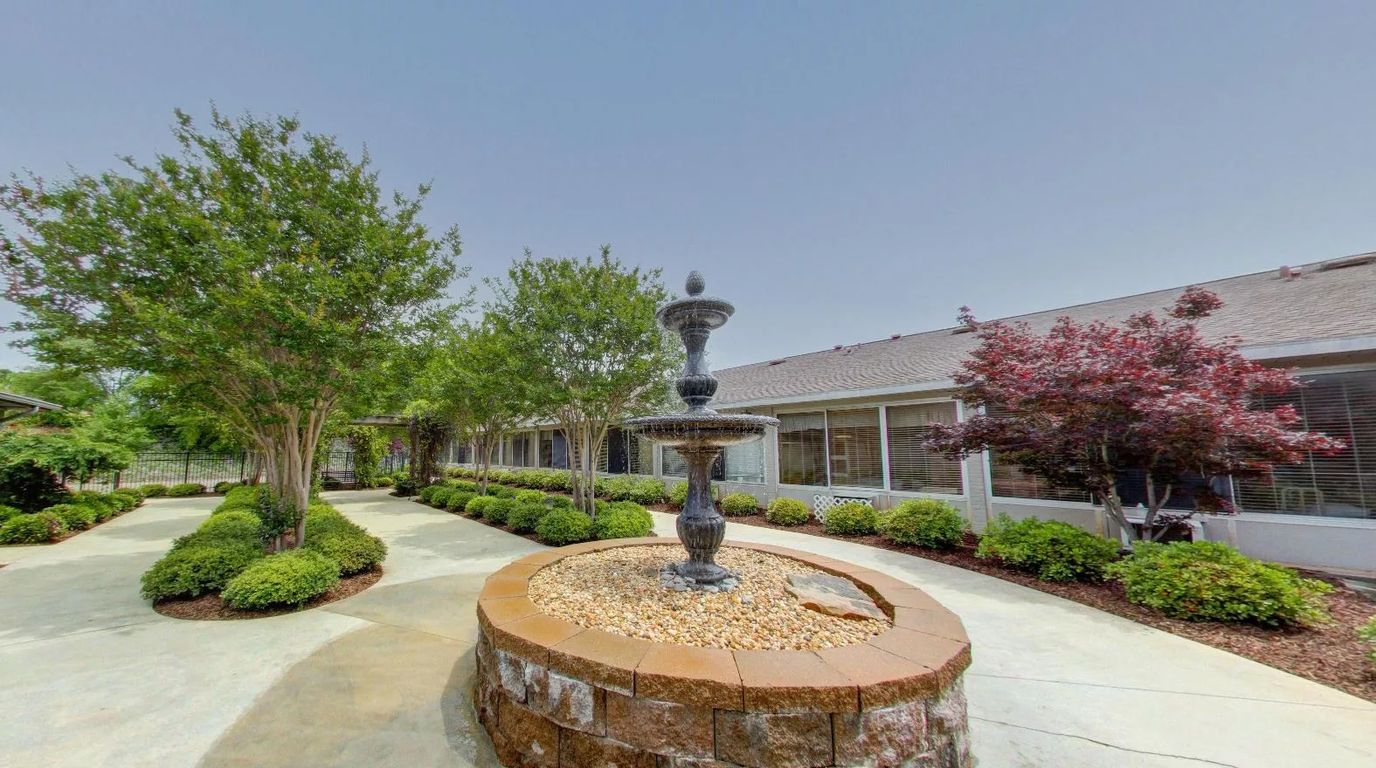 Garden area with a fountain and landscaped pathways