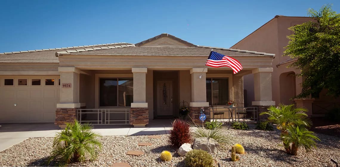 Exterior view of a residential building with an American flag