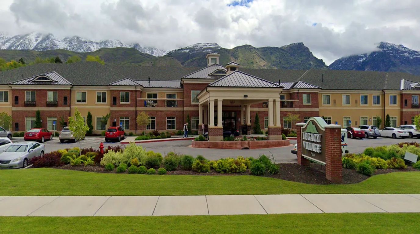 Exterior view of Legacy Village Provo facility with mountains