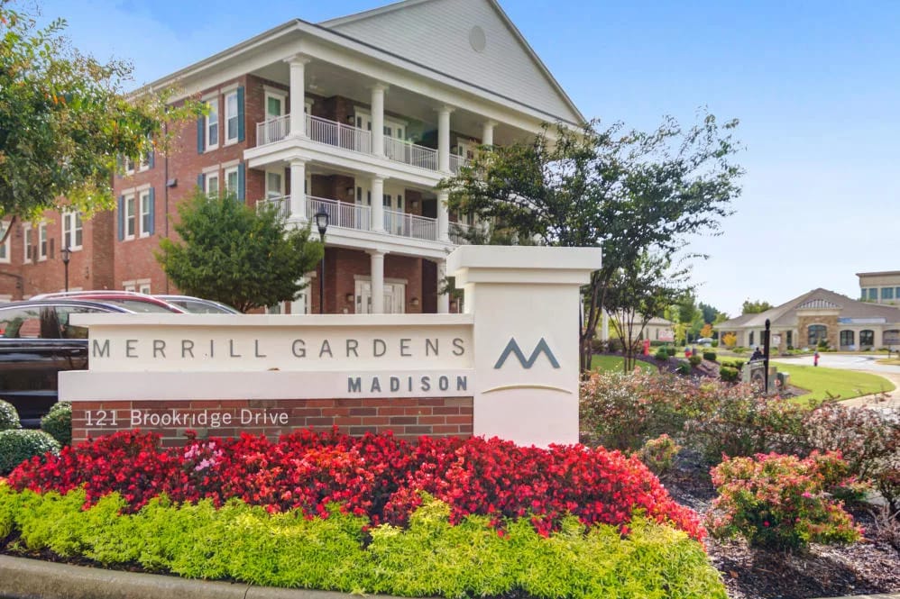 Exterior view of Merrill Gardens at Madison with landscaping