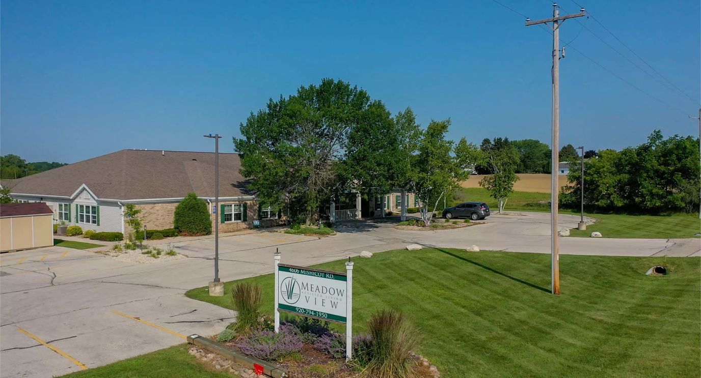 Aerial view of Meadow View Assisted Living facility with landscaped grounds