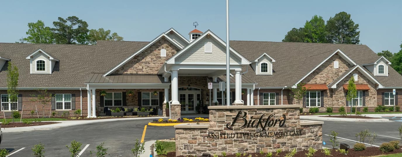 Front view of a senior living facility with landscaped entrance
