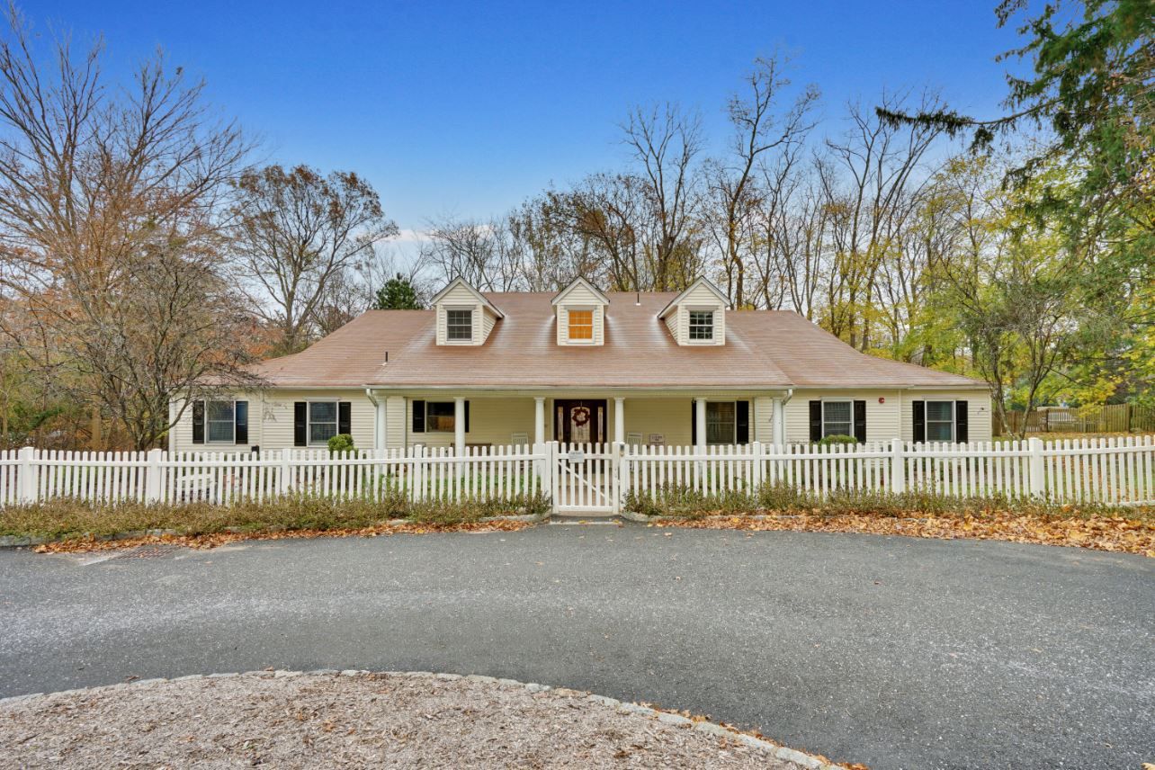 Exterior view of a nursing home building with a fence