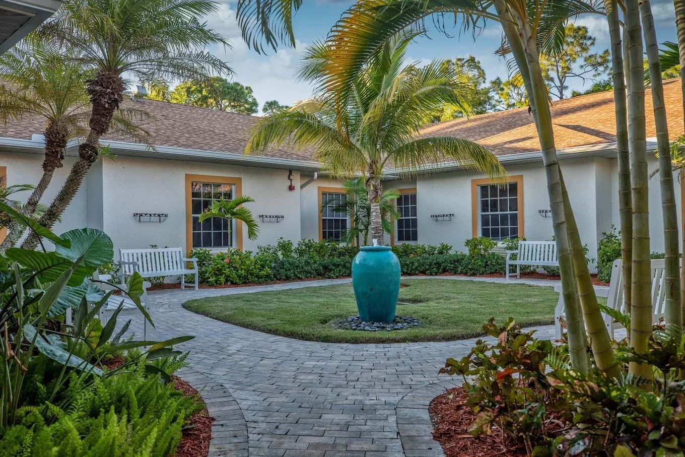 Lush courtyard with palm trees and benches