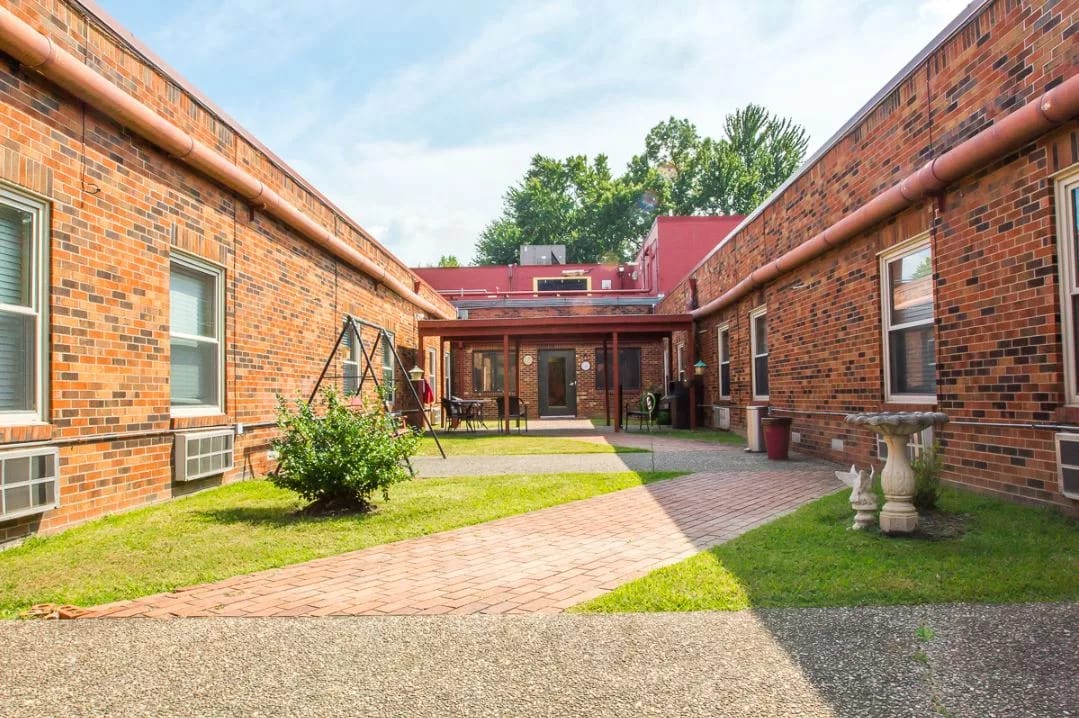 Outdoor courtyard with brick pathways and landscaping