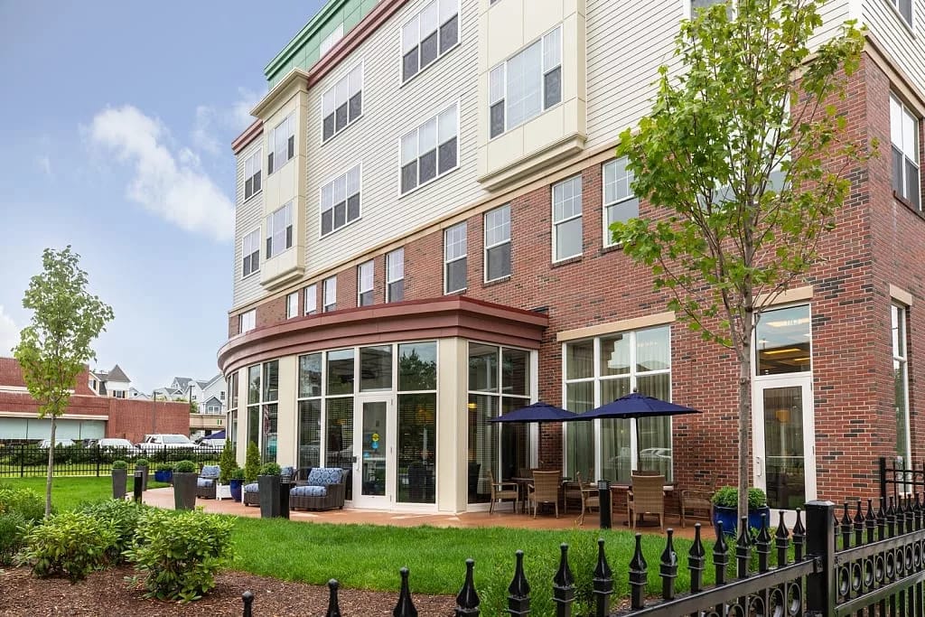 Exterior view of a senior living facility with landscaped area