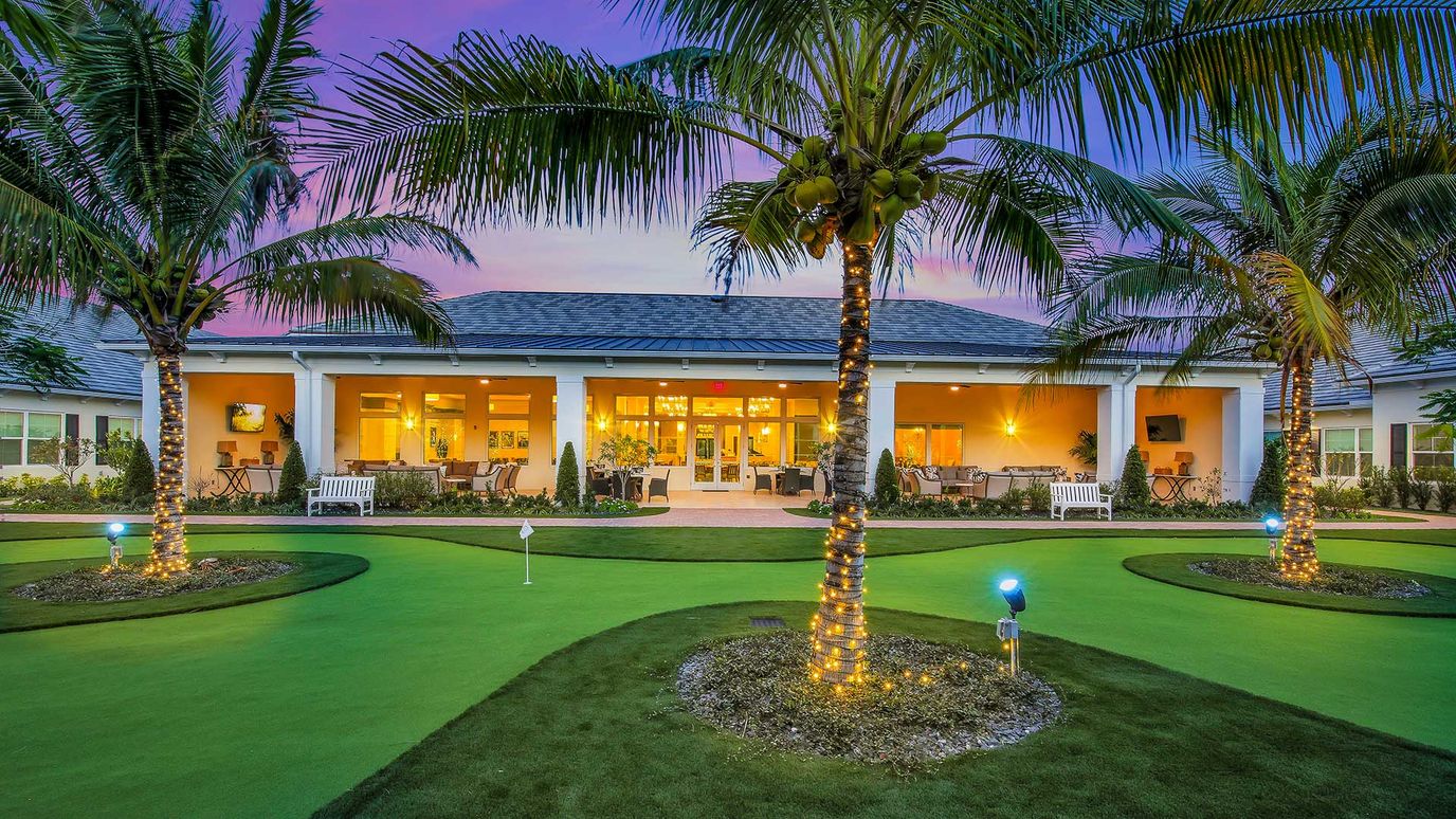 Beautiful exterior of Courtyard Gardens with palm trees and landscaped grounds