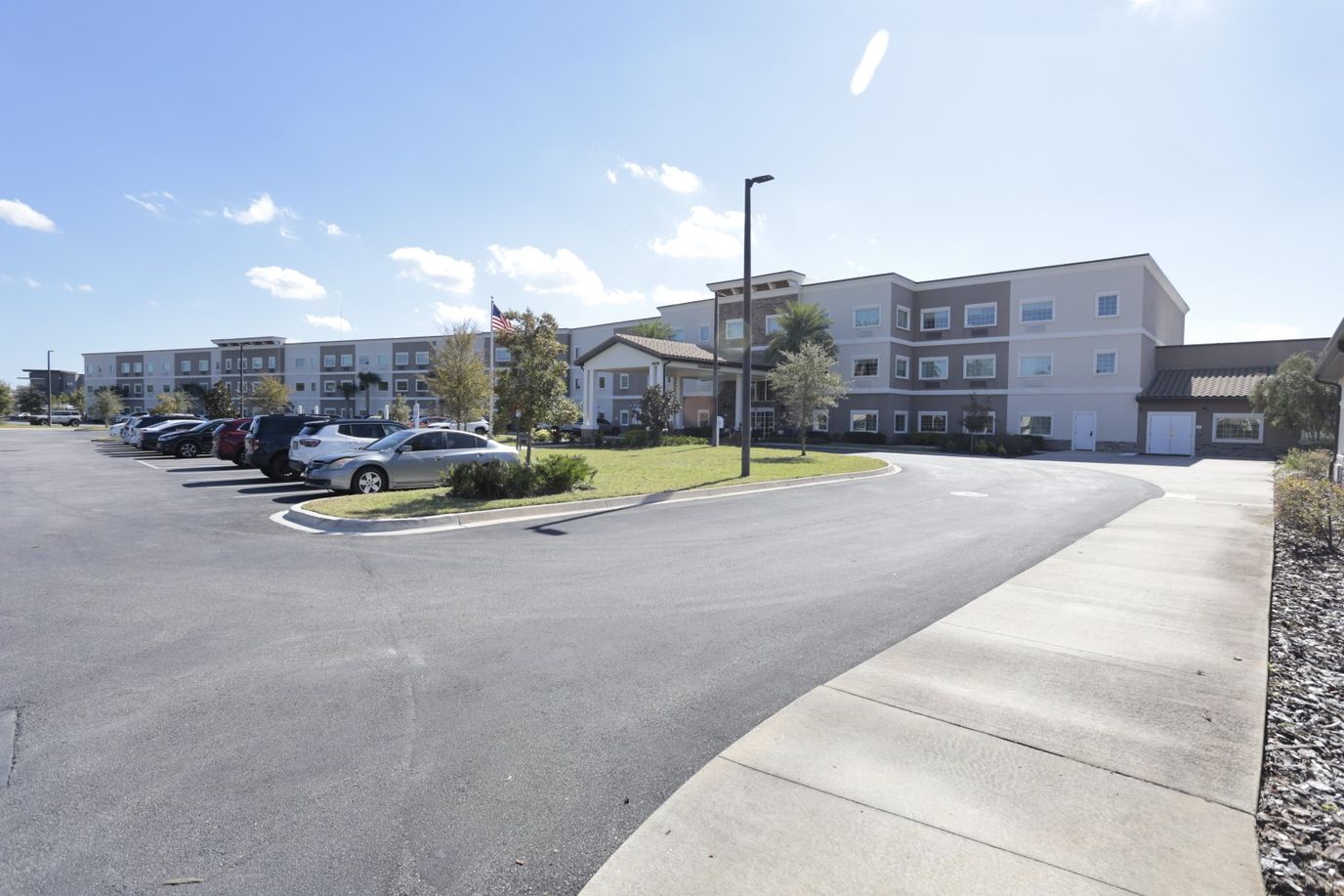 Exterior view of a senior living facility with landscaping