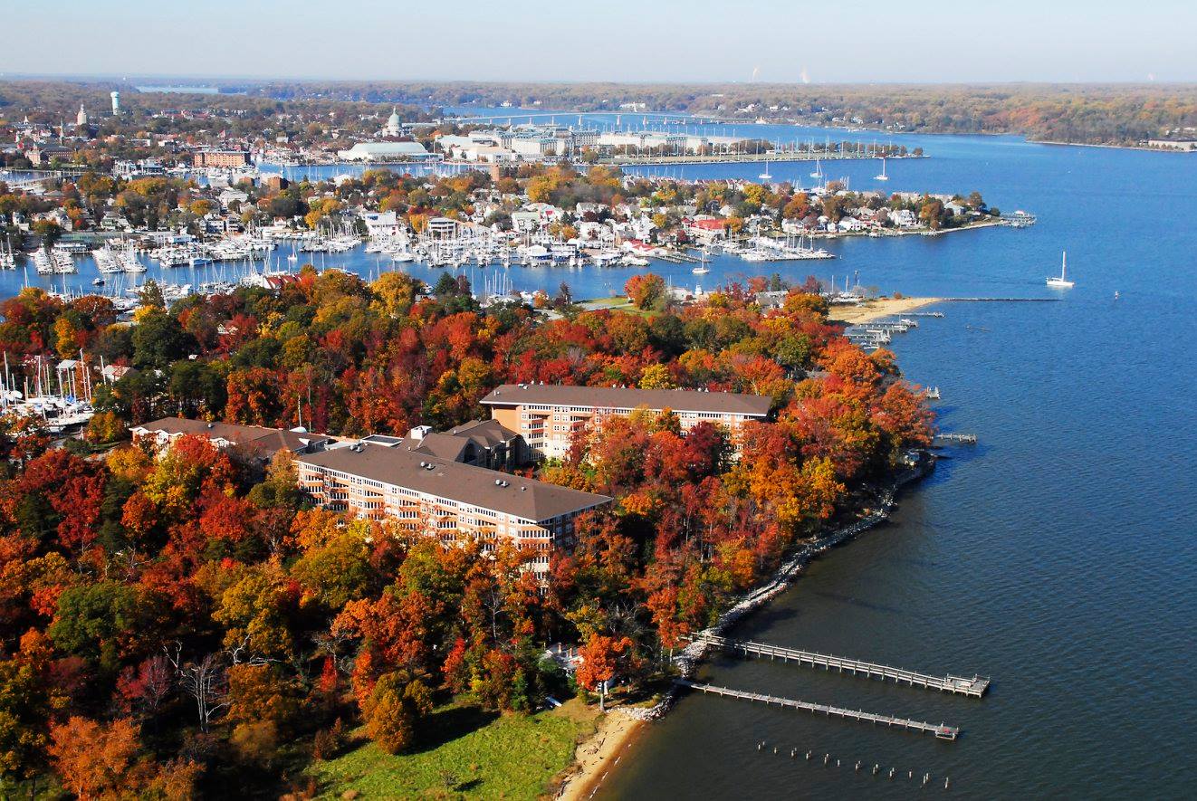 Aerial view of Baywoods of Annapolis surrounded by vibrant fall foliage