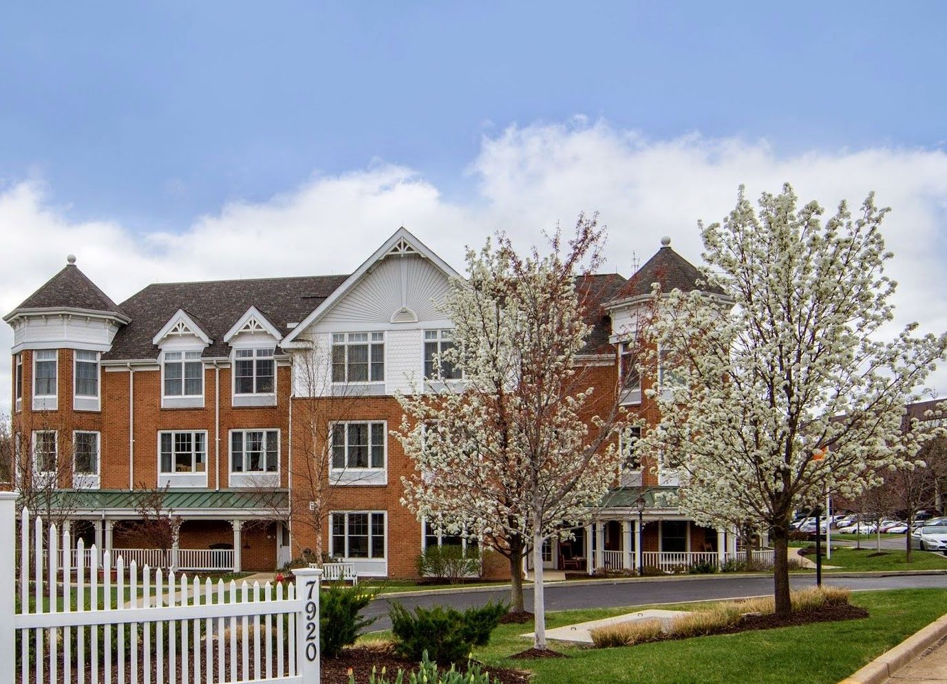 Exterior view of Fairmont Senior Living with blooming trees
