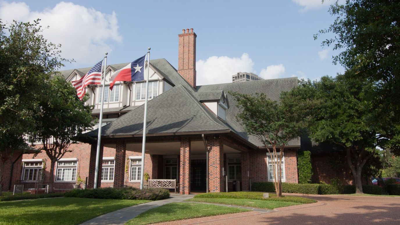 Exterior view of Houston Hospice with flags