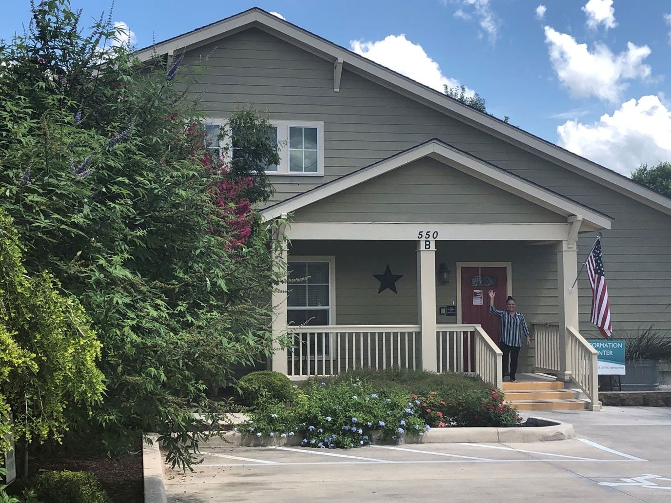 Exterior view of a senior living facility with a resident