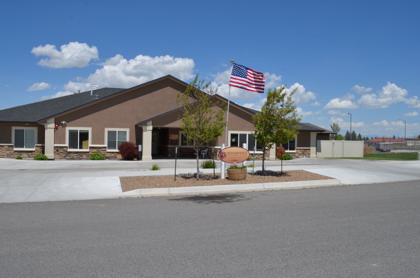 Exterior view of Renaissance Senior Care with flag