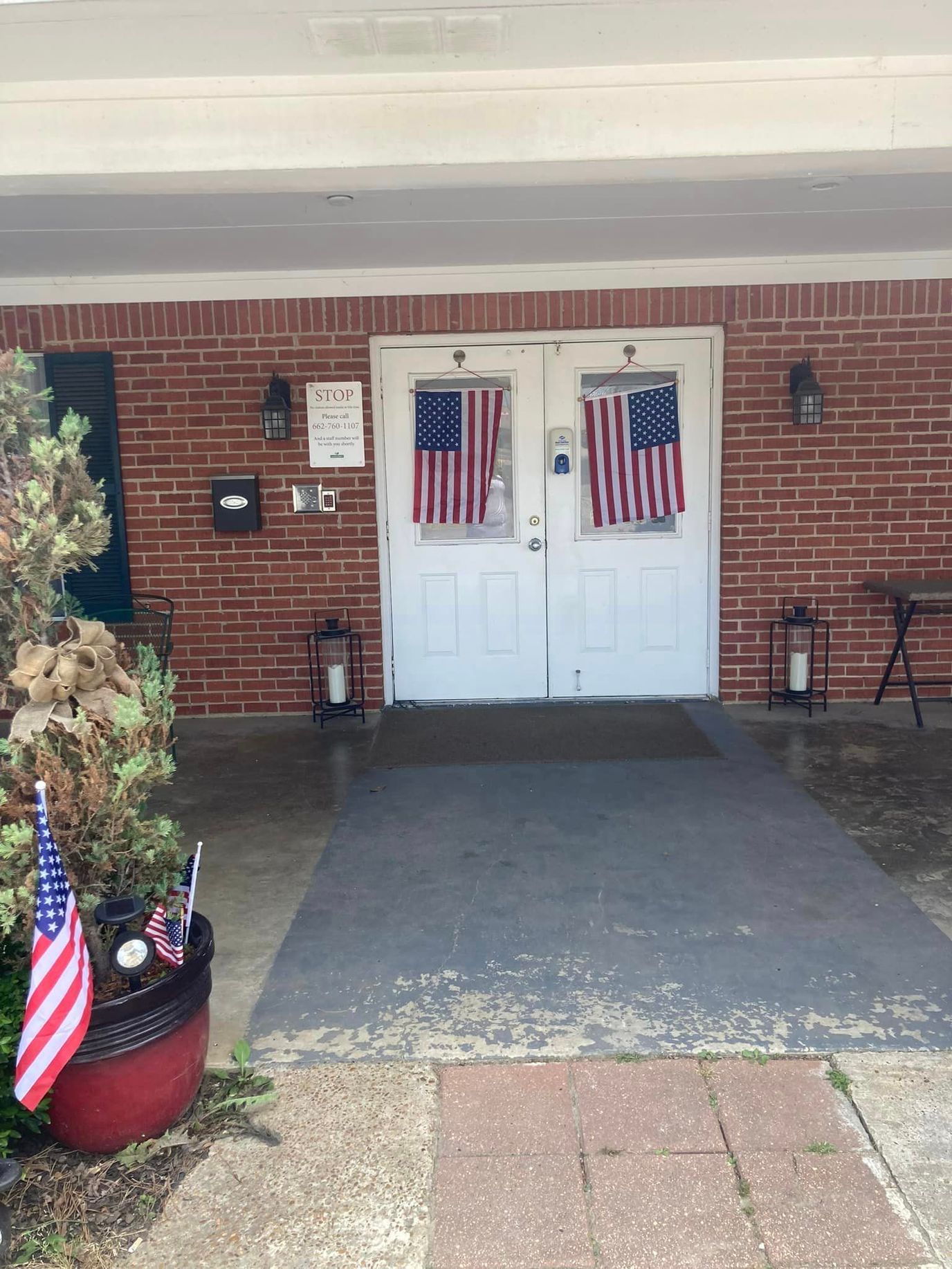 Entrance to a senior living facility decorated with flags