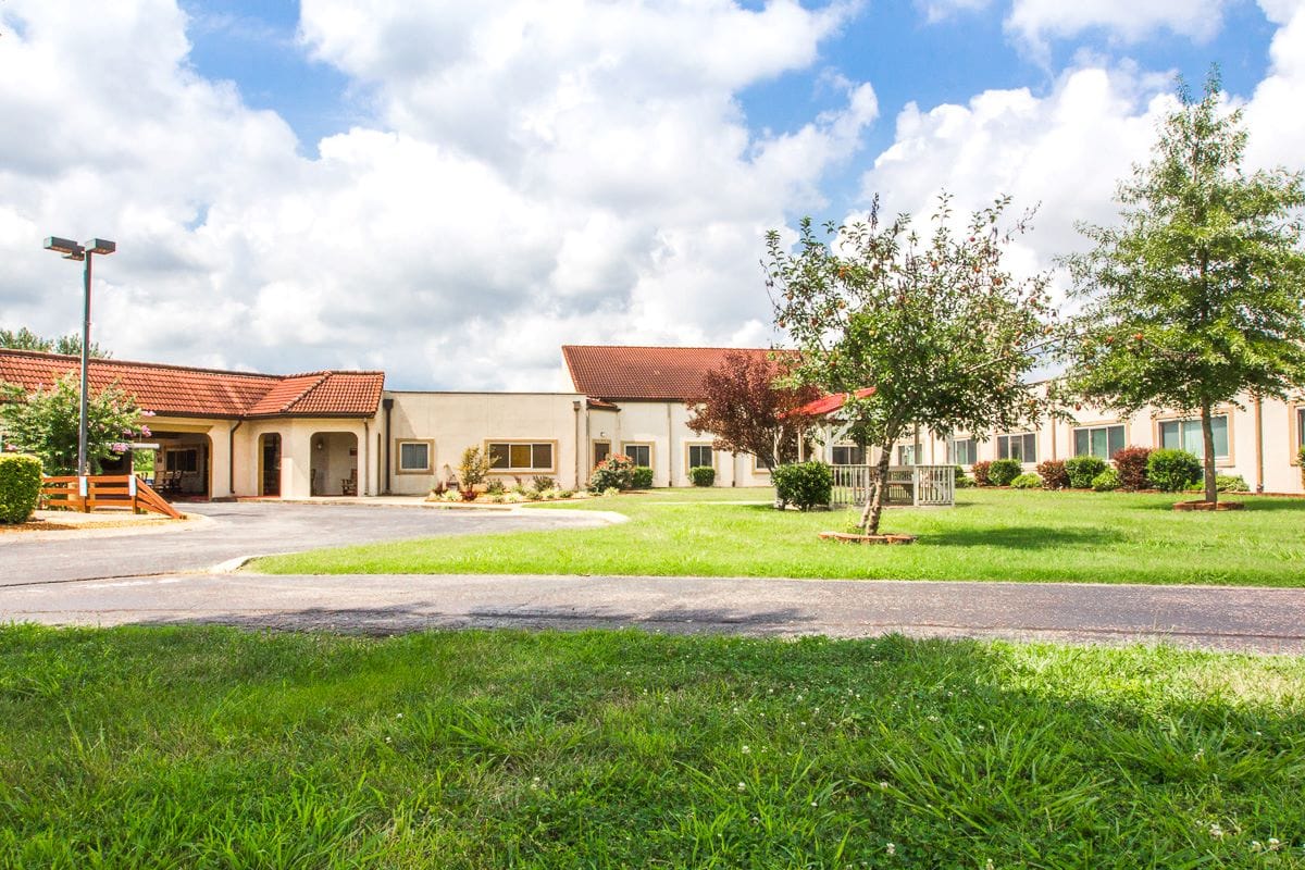 Exterior view of the nursing home with landscaped area