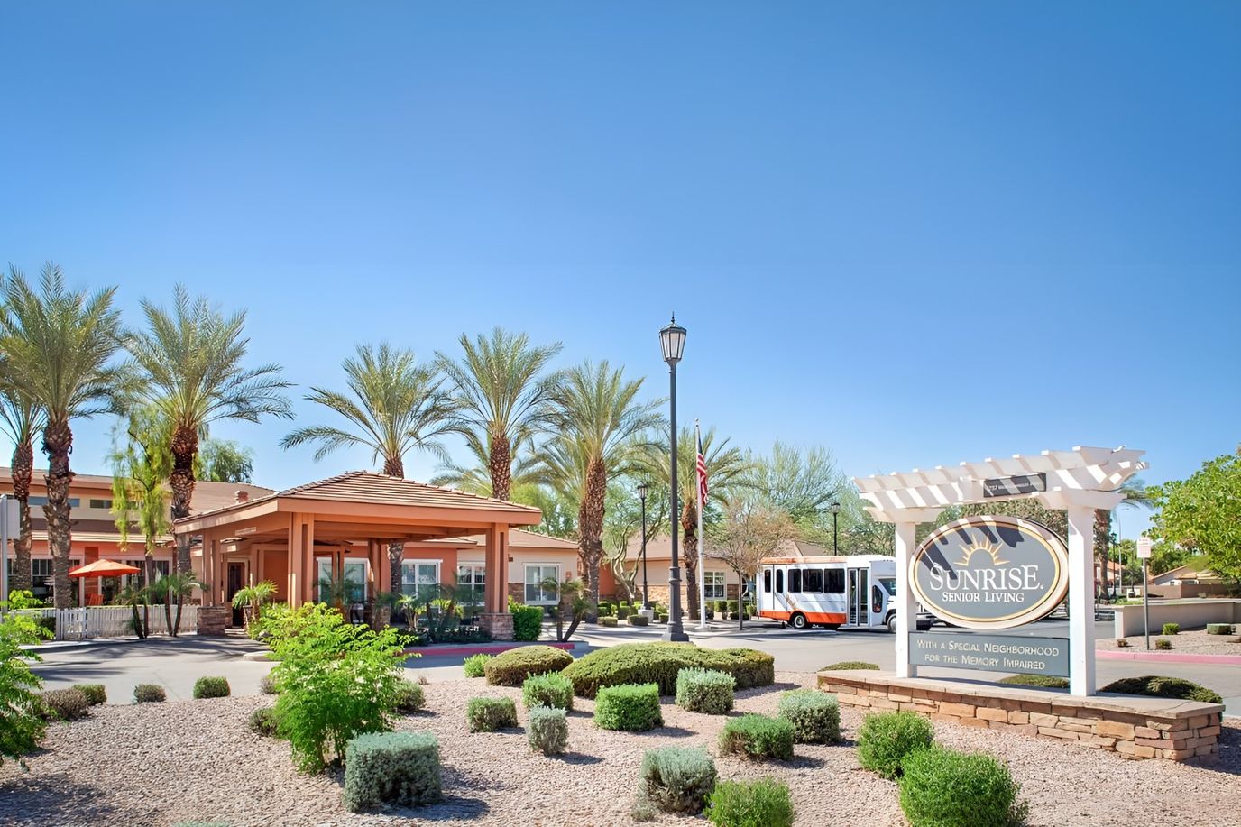 Exterior view of Sunrise of Chandler with landscaping and bus