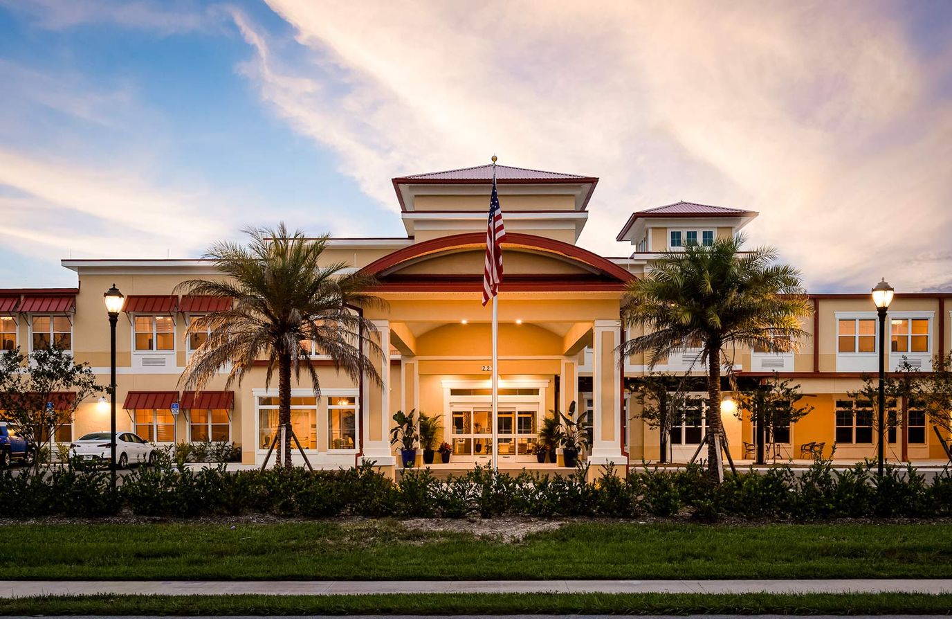 Exterior view of a senior living facility at sunset