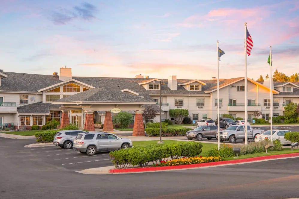 Exterior view of Touchmark on Saddle Drive with flagpoles and cars