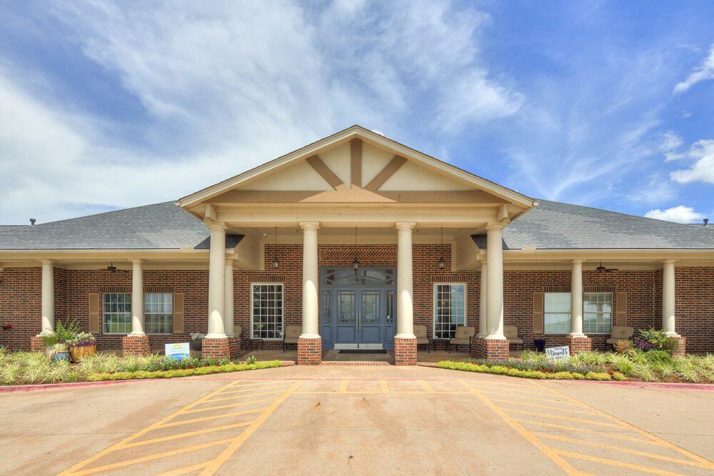 Front entrance of assisted living facility with landscaping
