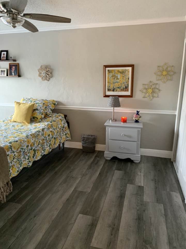 Cozy resident room with floral decor and warm lighting.