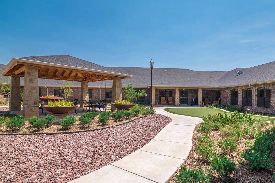 Outdoor space with landscaped pathways and seating areas