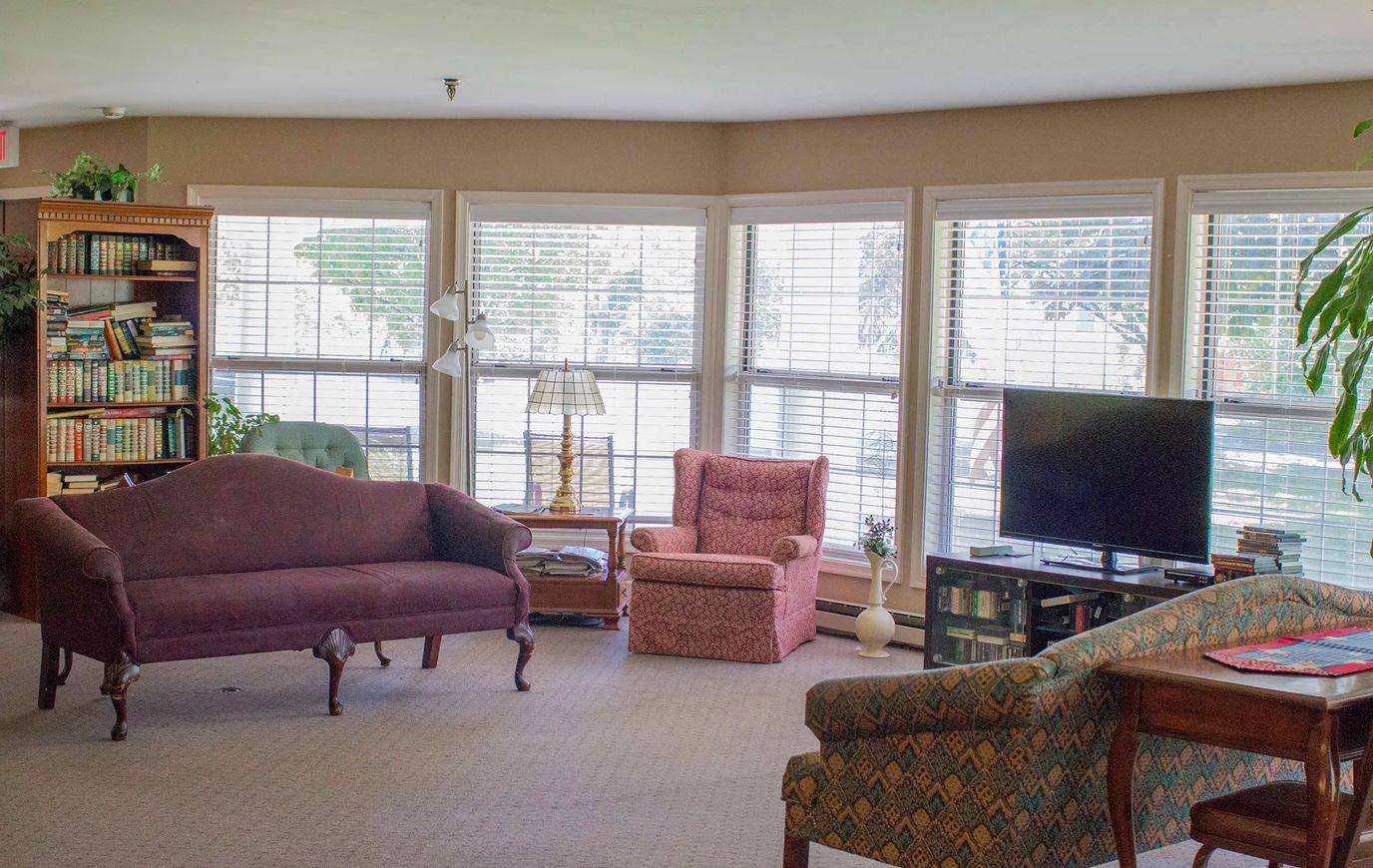 Comfortable common area with seating and bookshelves