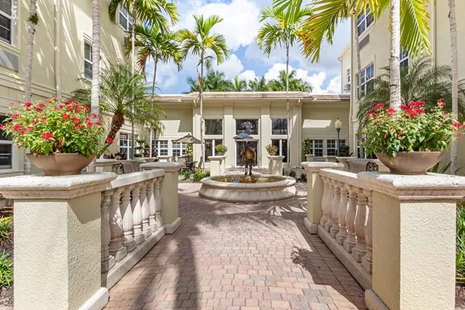 Lush courtyard with a fountain and palm trees