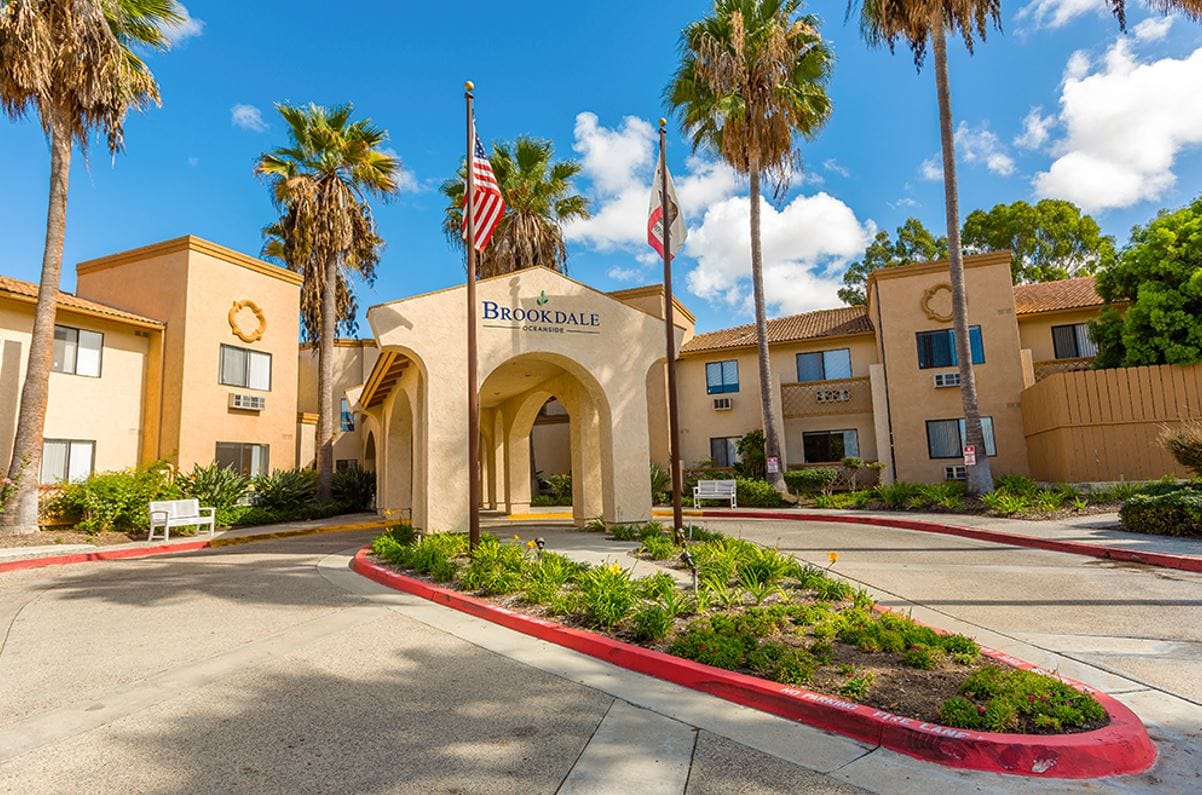 Exterior view of Brookdale Oceanside with palm trees