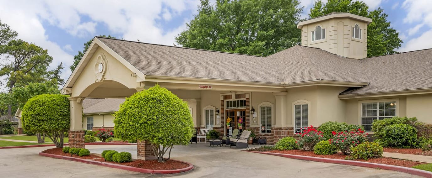 Front entrance of a senior living facility with landscaping