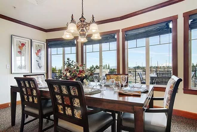 Elegant dining area with large windows and a table set