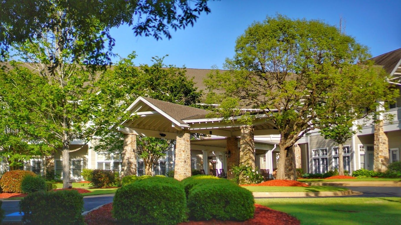 Exterior view of a senior living facility with landscaped gardens