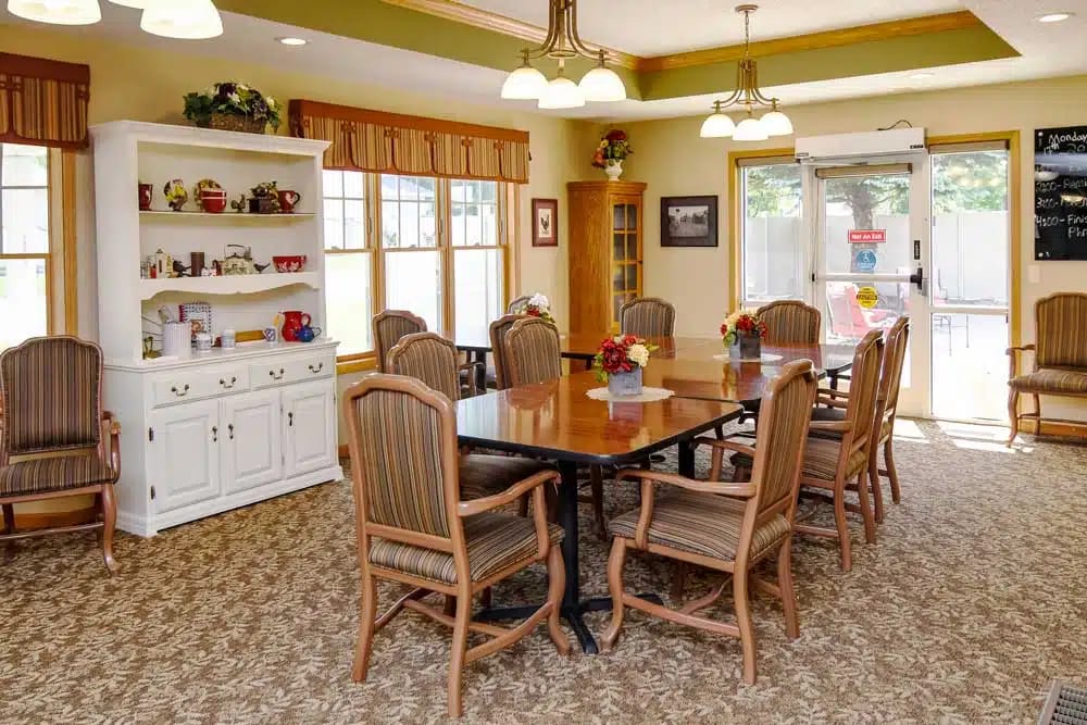 Bright common area with dining tables and chairs
