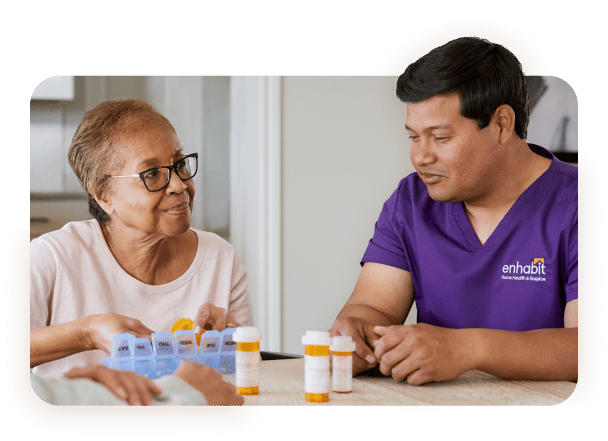 Staff member assisting a resident with medication management