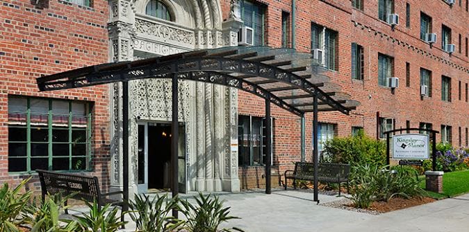 Exterior view of Kingsley Manor entrance with decorative awning