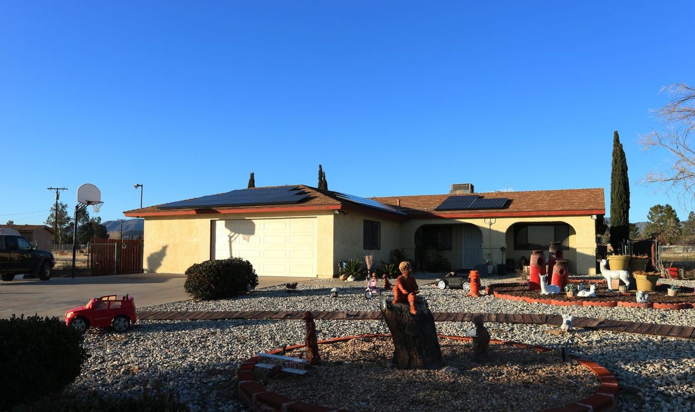 Exterior view of a single-story residence with landscaping