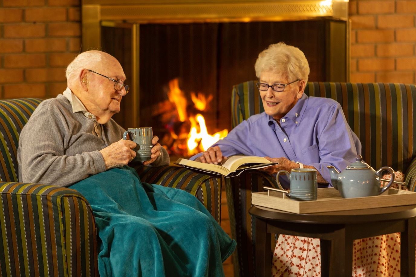 Residents enjoying a cozy reading time by the fireplace
