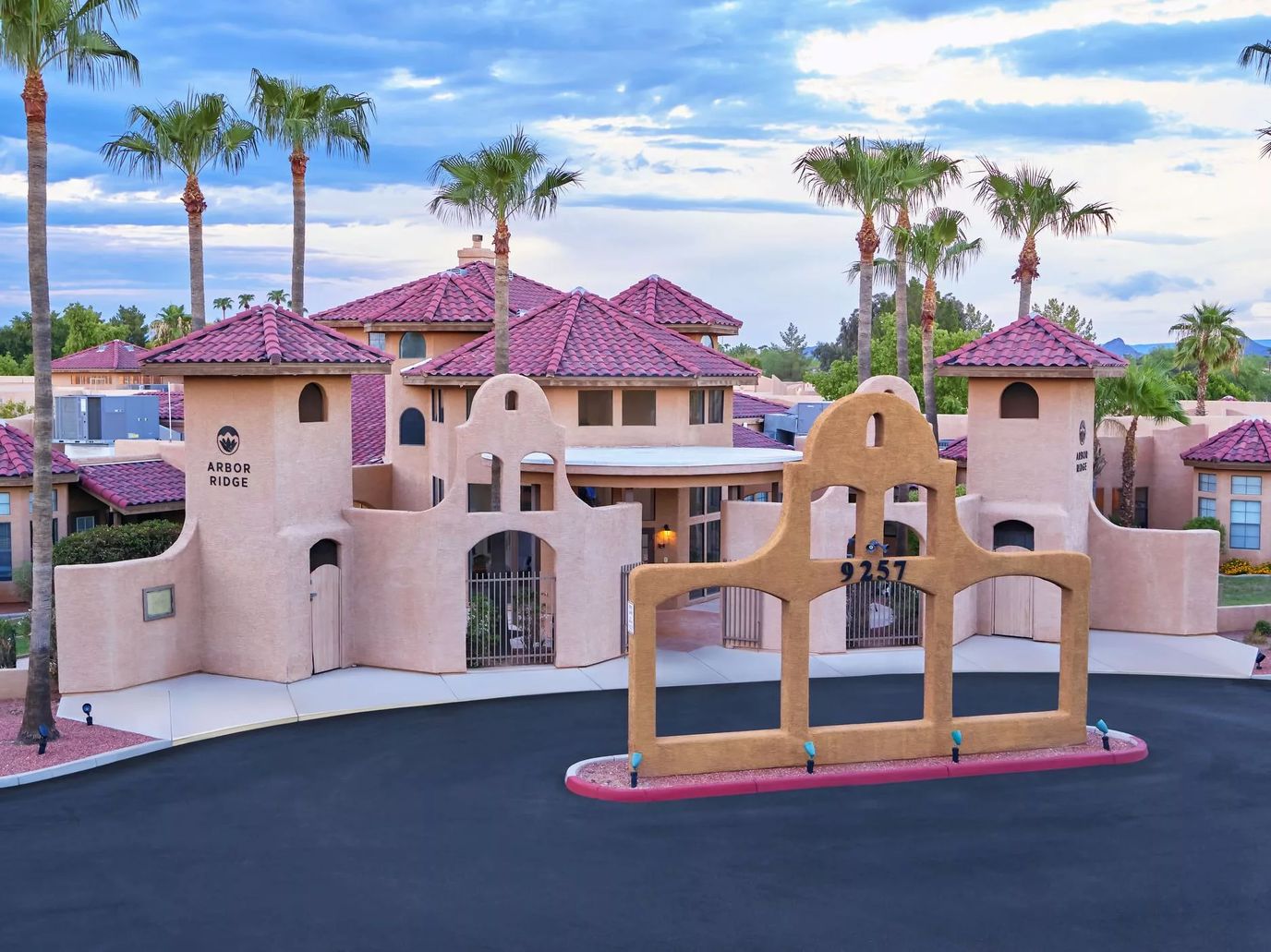 Exterior view of the senior living facility with palm trees