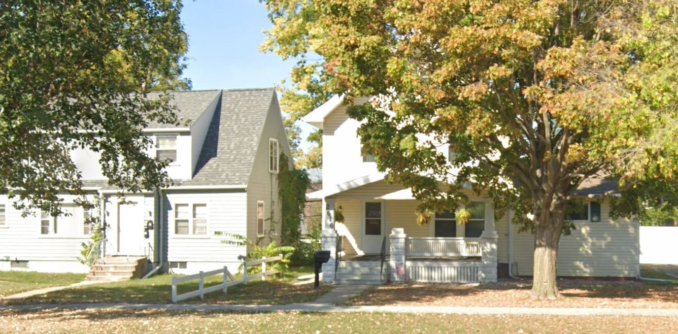 Exterior view of a senior care facility with trees