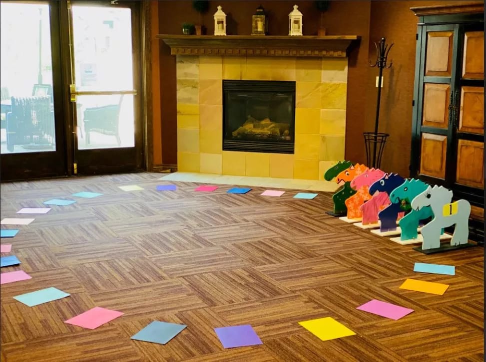 Common area with a fireplace and colorful decorations on the floor
