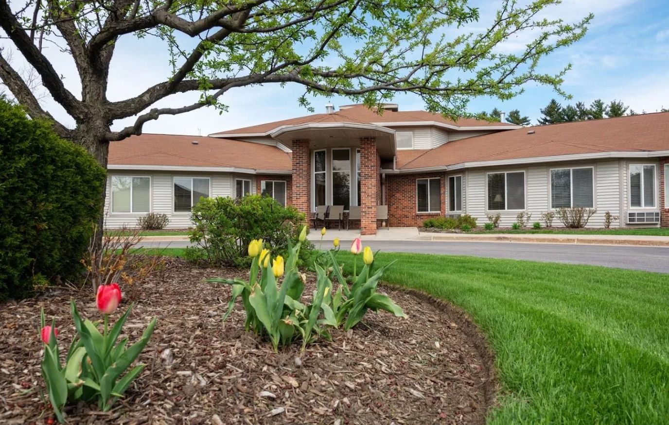 Exterior view of a nursing home with garden flowers