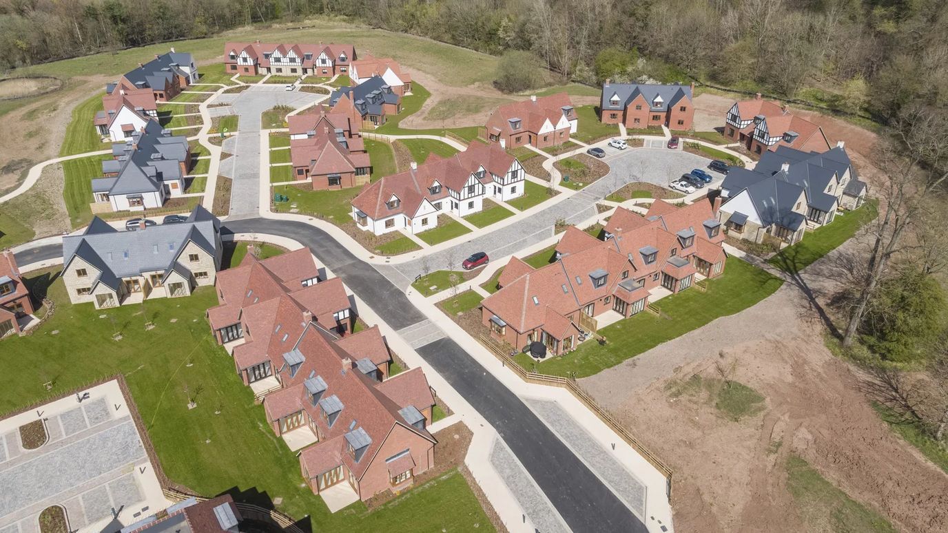 Aerial view of a senior living community with homes and gardens