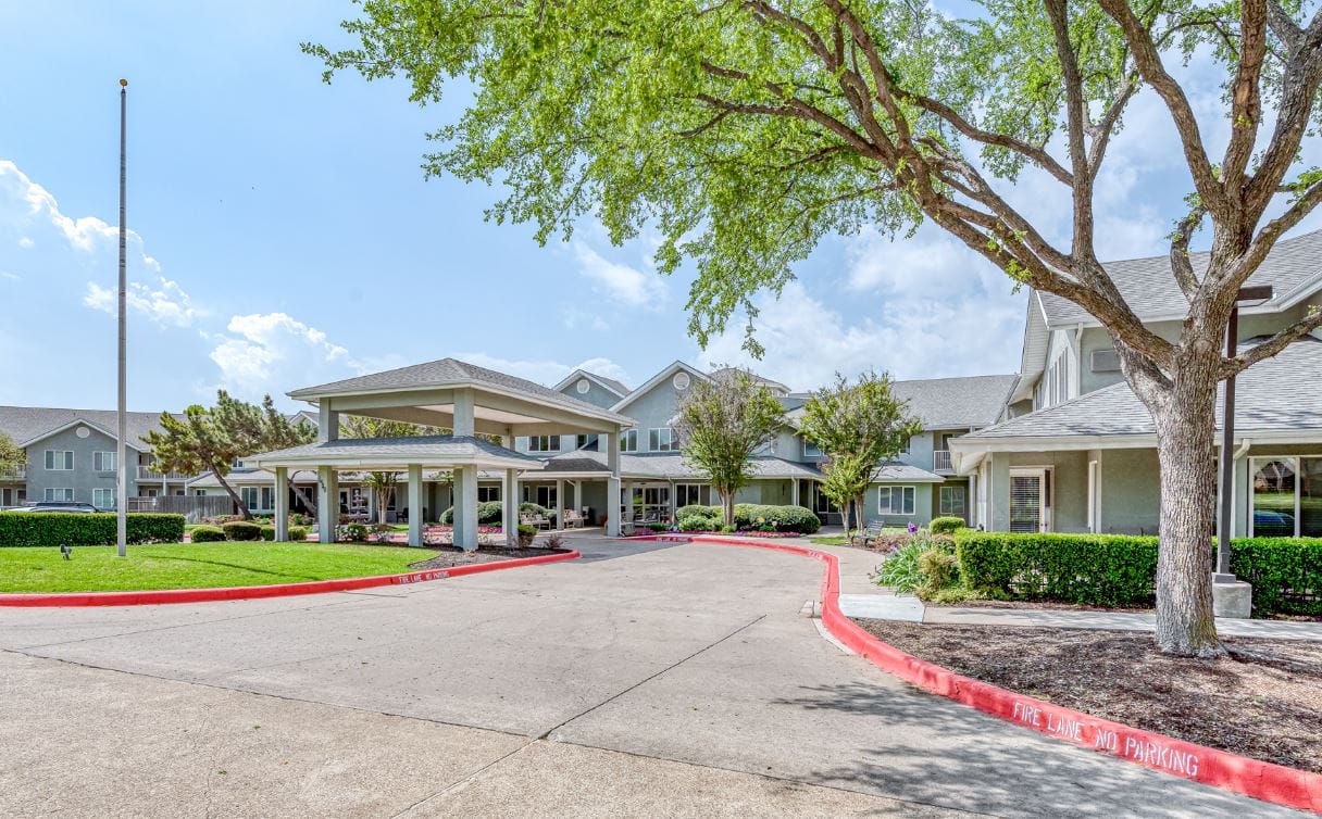 Welcoming entrance of Solstice Senior Living with gardens